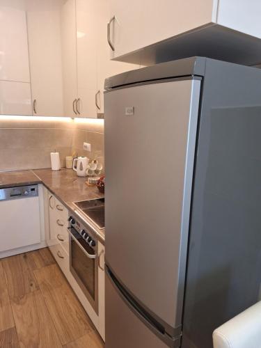 a kitchen with a stainless steel refrigerator at DRAGAm in Banja Luka