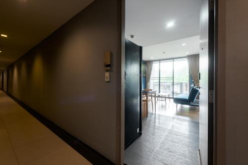 a hallway with a door leading to a living room at Panoramic Pool at The Valley in Pak Chong