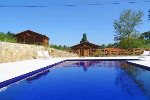 a swimming pool with a house in the background at Casa Gil, Quinta Carmo - Alcobaça/ Nazaré in Alcobaça