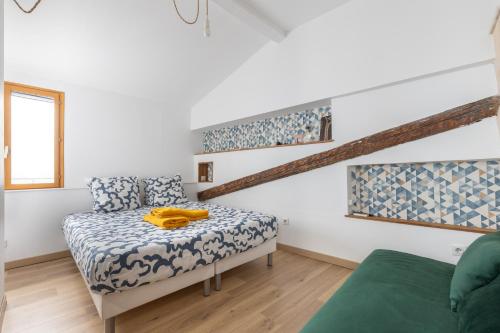 Cette chambre blanche dispose d'un lit et d'un canapé. dans l'établissement La clé des remparts - 3 chambres - Wifi - Intramuros, à Avignon