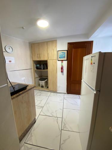 a kitchen with a white refrigerator in a room at The hidden Place in Alcaudete