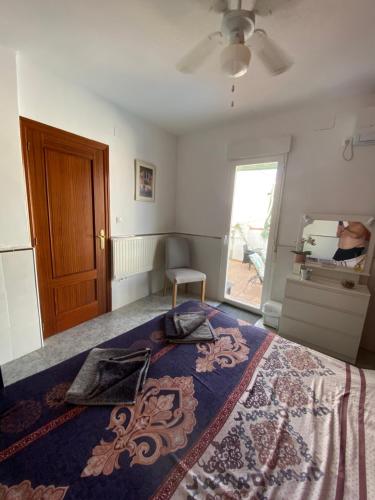 a bedroom with a bed and a ceiling fan at The hidden Place in Alcaudete