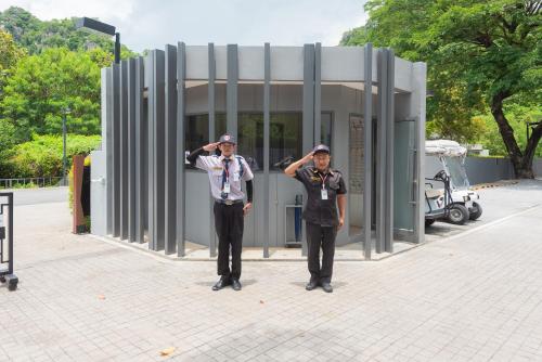 two men in uniform standing in front of a building at Panoramic Pool at The Valley in Pak Chong