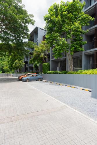 a car parked in a parking lot next to a building at Panoramic Pool at The Valley in Pak Chong
