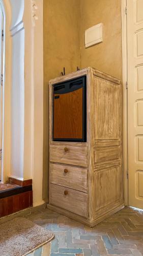 a wooden dresser with a tv on top of it at PALACIO AL ANDALUS in Chefchaouene