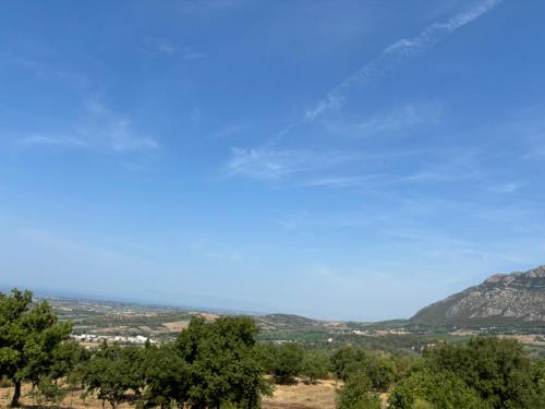 a clear blue sky with trees and mountains in the background at B&B CASA MARTINA in Giungano