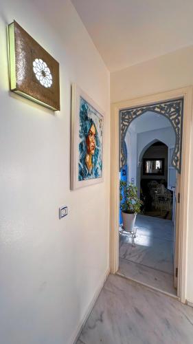 a hallway of a home with a painting on the wall at PALACIO AL ANDALUS in Chefchaouene
