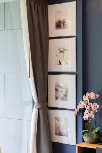 a curtain with pictures on a wall next to a window at The Valley at Sunshine, Panoramic in Pak Chong