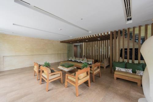 a living room with a table and chairs at The Valley at Sunshine, Panoramic in Pak Chong