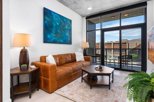 a living room with a couch and a large window at Downtown SLC Luxury 1BD 1BA - Pool HotTub 24hrGym in American Towers Condominium