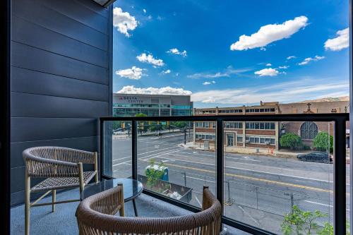 a balcony with two chairs and a view of a street at Downtown SLC Luxury 1BD 1BA - Pool HotTub 24hrGym in American Towers Condominium