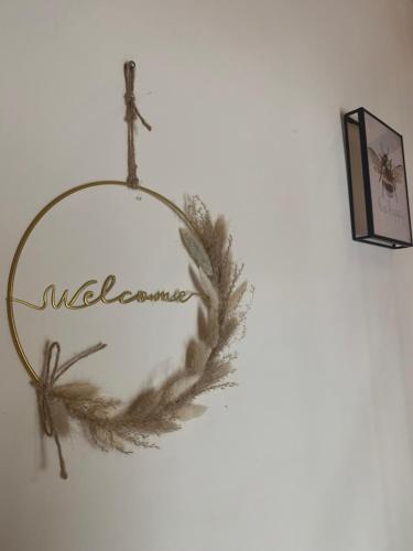 a wreath on a wall with the word welcome at La Grange du Domaine in Saint-Maden