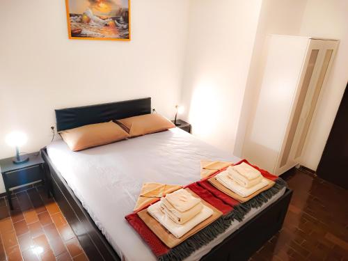 a bedroom with a bed with two towels on it at Mila's pet friendly holiday house in Pag