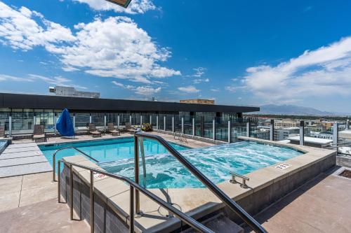 a swimming pool on the roof of a building at Downtown SLC Luxury 1BD 1BA - Pool HotTub 24hrGym in American Towers Condominium