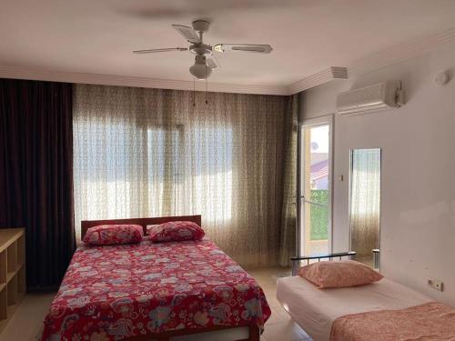 a bedroom with a bed and a window at Mercan Villa in Yenihisar
