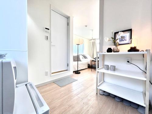 a living room with a mirror and a white room at Shinjuku YC Hostel-SJ0399 in Tokyo