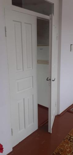 a white door in a room with a closet at სახლი ბუნებაში House in nature in Tsikhisdziri