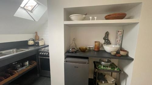 a small kitchen with a sink and a counter top at De Hamrokerij in Kortrijk