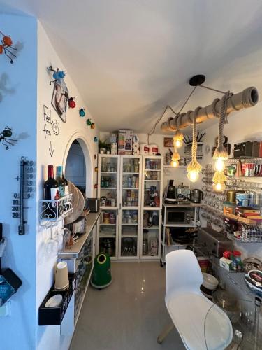 a shop with white chairs in a room at FLAT Surrounded by Nature WIFI & Pool & beach Nearby in Son Parc