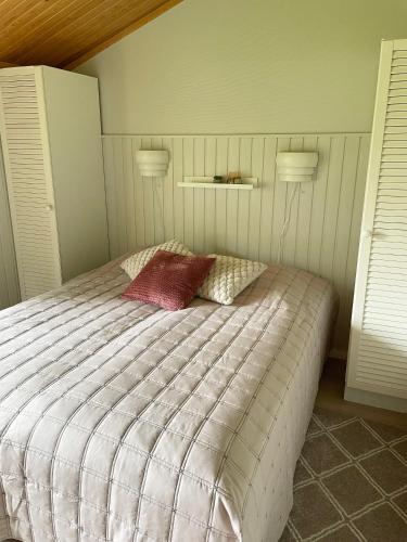 a bedroom with a bed with two pillows on it at Talvijärven Kuura in Ruka