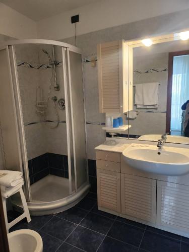a bathroom with a sink and a shower at Villa rosa in Loano