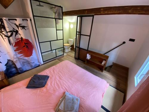 - une chambre avec un lit rose dans l'établissement Petite maison indépendante ambiance zen, à Saint-Savournin