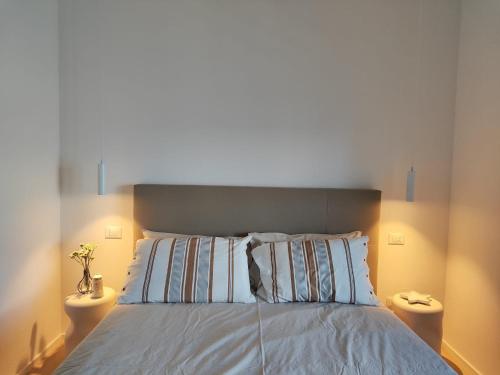 a bedroom with a large bed with two night stands at Casa Cotone 5 in Marciana Marina