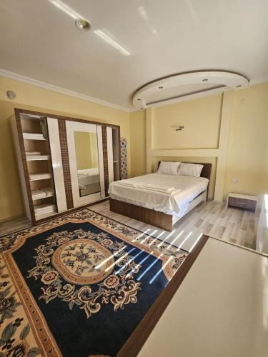 a bedroom with a bed and a large rug at Senfoni Cave Village in Nar