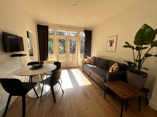 a living room with a couch and a table at Intimate independent apartment, Centre Dordrecht in Dordrecht