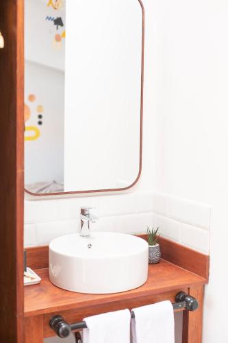 a bathroom with a white sink and a mirror at Solara Art Hotel by Amak in Cusco