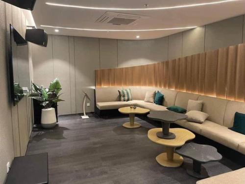 a waiting room with a couch and two tables at The Sóng Luxury Apartment Vung Tau - Tuấn Hoà Homestay in Vung Tau