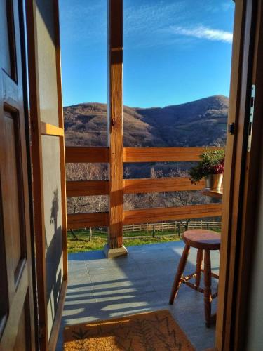 a view from the door of a porch with a stool at Šumski kutak in Rudnik Kačerski