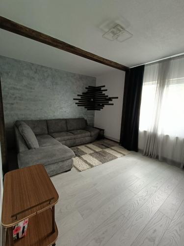 un soggiorno con un divano e un tavolo di Casa Piatra Corbului a Gura Teghii