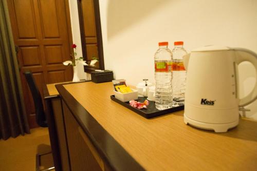 a coffee maker and bottles of water on a counter at Samara Resort in Batu