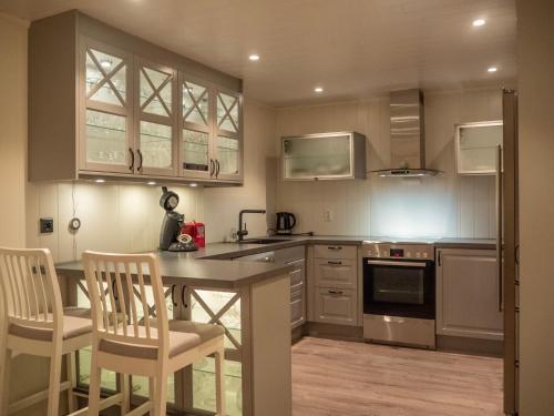 a kitchen with a table and chairs in it at Nordic Rest in Båtsfjord