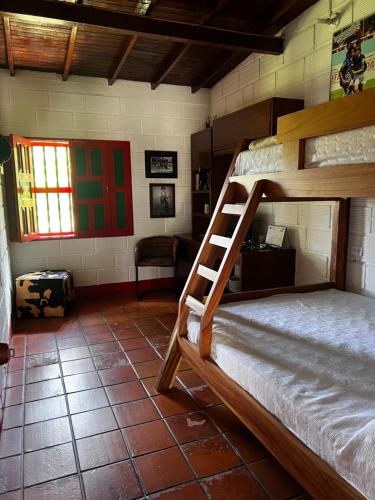 a bedroom with a bunk bed in a room at Finca la frondosa - La frondosa farm in Angelópolis