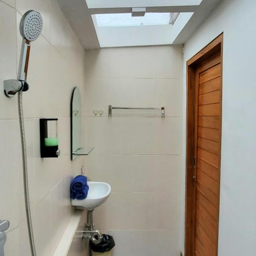 a bathroom with a sink and a shower at Kabinku Bali in Bedugul