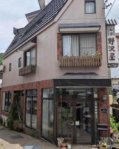 a store front of a building with a window at Oyado Nozawaya in Nozawa Onsen
