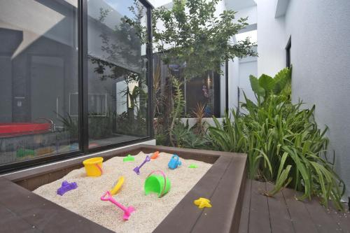 a sandbox with toys in the sand on a patio at Voga Motel in Taichung