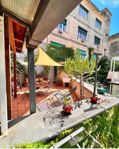 a patio with a table and chairs and a building at Isabel’s house in Vietri sul Mare