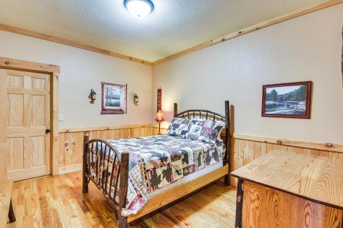 a bedroom with a bed and a wooden floor at Expansive Sky Valley Lodge with Mountain Views! in Sky Valley