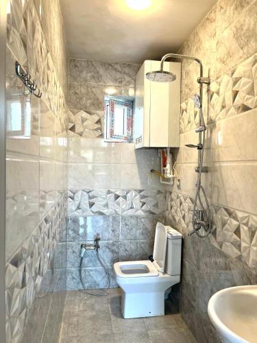 a bathroom with a toilet and a sink at Blue Pool Paradise in Gabala