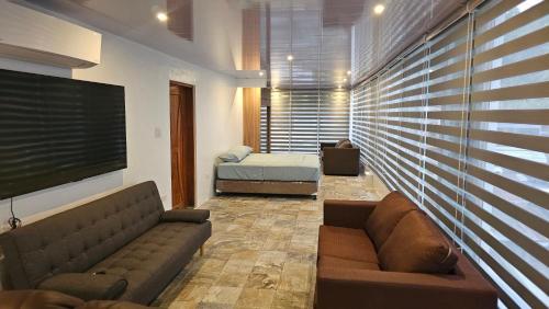 a living room with a couch and a bed at Lydia's House in Kaputian