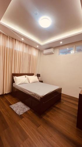 a bedroom with a large bed and a window at Camilles Pension House in Puerto Princesa City