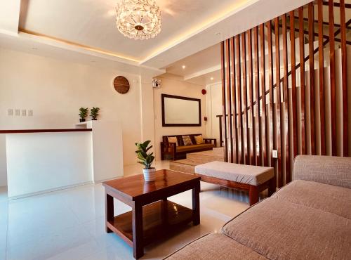 a living room with a couch and a table at Camilles Pension House in Puerto Princesa City