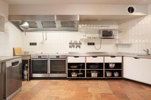 a large kitchen with stainless steel counters and appliances at Smilovický Mlýn in Rakovník