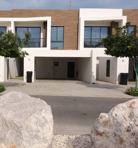 a building with a large rock in front of it at Relaxing villa with access to pool and beach in Ras al Khaimah
