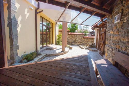 a porch of a house with a wooden deck at Къща за гости ANGELOVI in Veliko Tŭrnovo