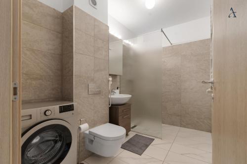 a bathroom with a washing machine and a toilet at Maia Apartment with One Bedroom & Fully kitchen in Bucharest