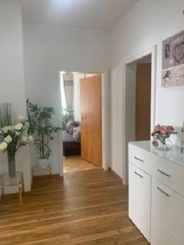 a living room with a kitchen and a hallway at Ferienwohnung Dinh in Uhldingen-Mühlhofen